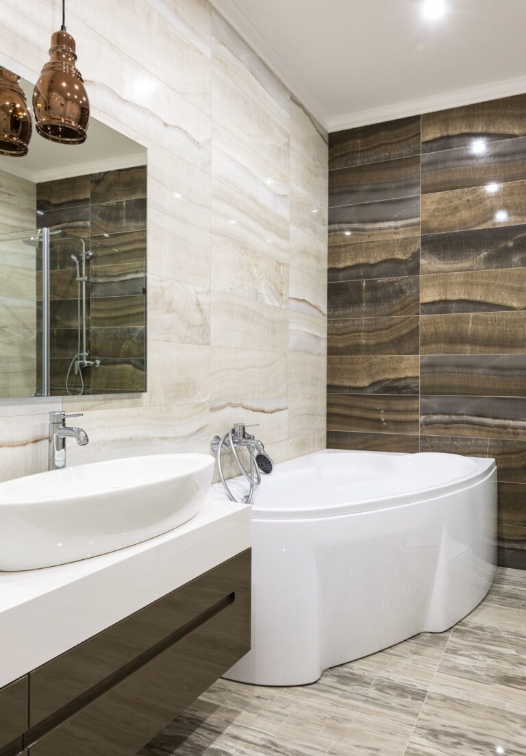 Contemporary bathroom design featuring sleek white fixtures and stylish tiles. This article shares a complete guide to walk-in tubs and safter bathroom design.