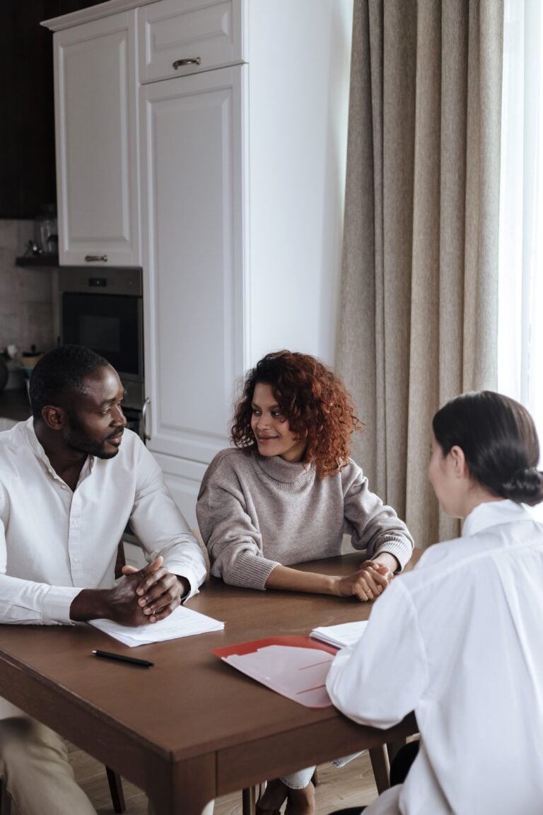A couple discusses with a consultant at home, capturing a casual business meeting. This article explains why estate planning matters before you need it.