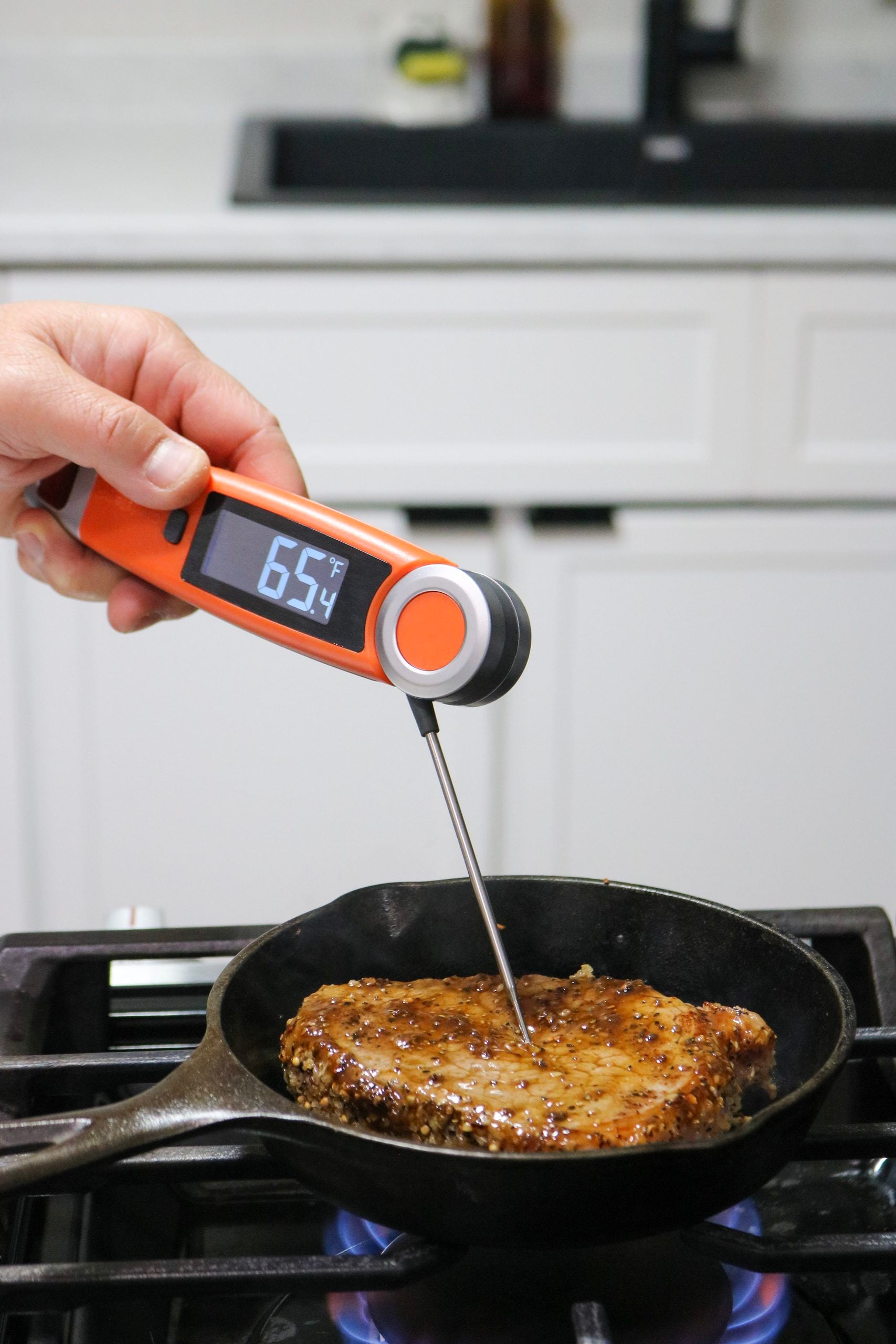 Another must-have in this ultimate fall outdoor cooking and patio guide. This ChefsTemp Finaltouch X10 digital instant read thermometer is perfect for indoor and outdoor cooking. It is shown testing a piece of steak on a cast iron.