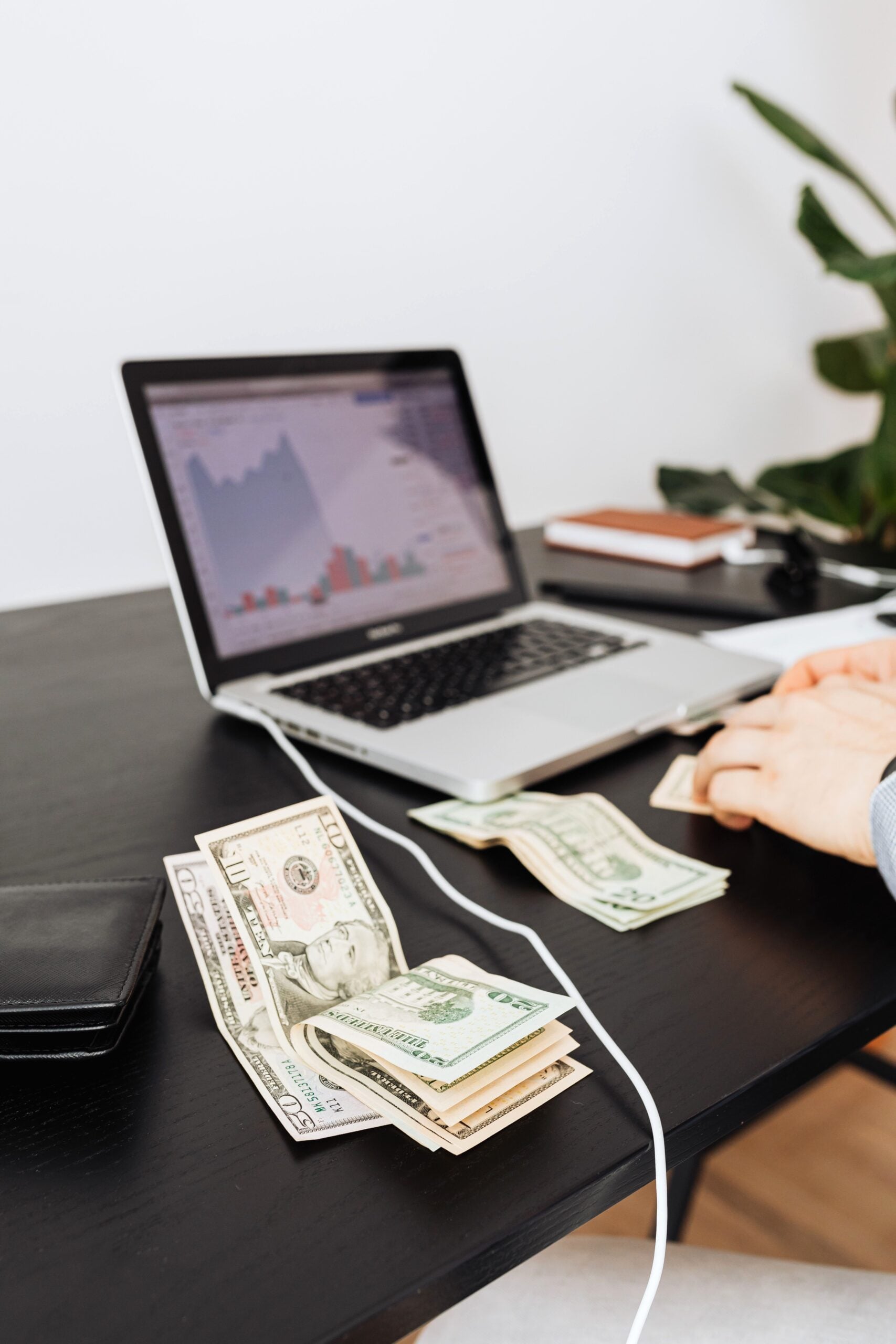 Money and laptop on desk indicating financial work or analysis. Perfect for business themes. This article covers how the foreign earned income exclusion lowers your US tax bill.