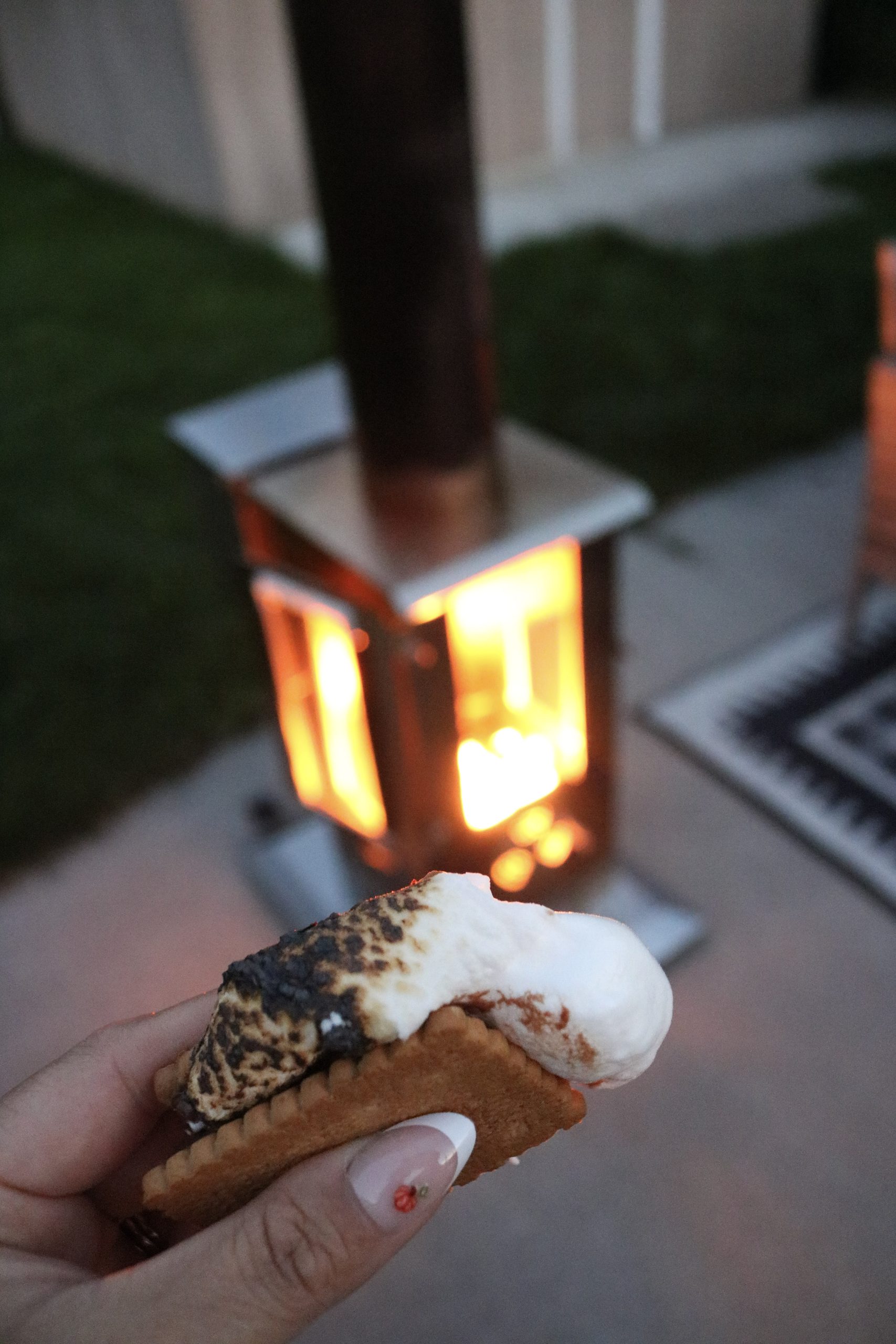 Nancy holds a s'mores made with Celebration cookies with a roasted marshmallow from the Timber Stove, Big Timber.